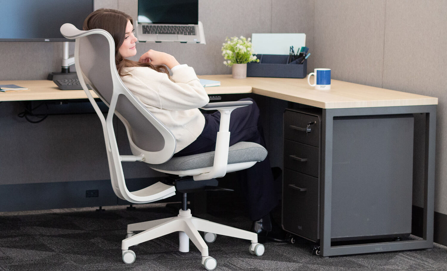 professional standing in home office setting with ascent chair 